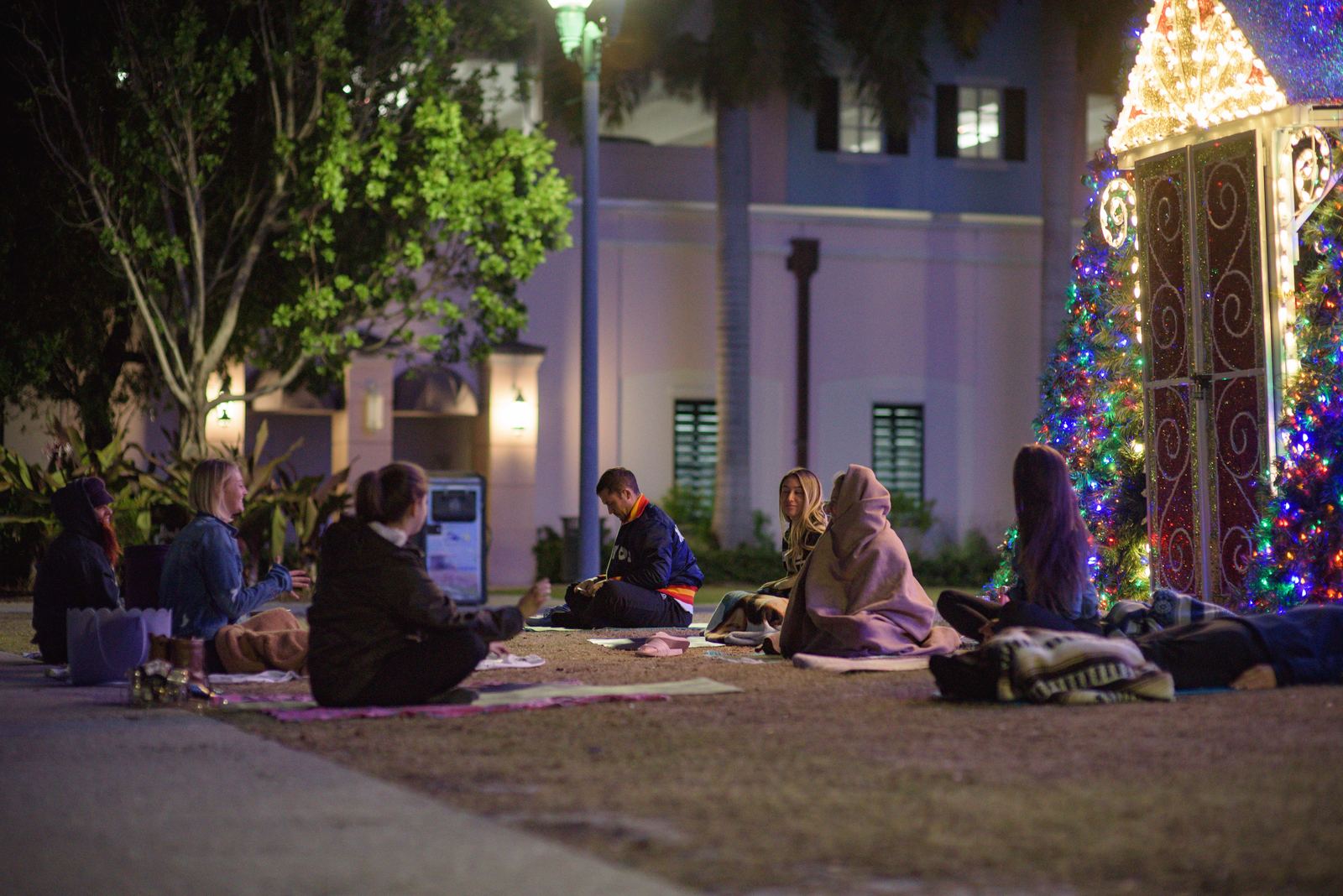 A community yoga class beside the Delray Beach 100-foot Christmas tree